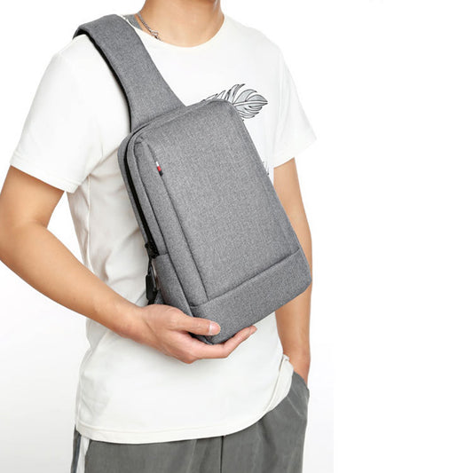 Light grey sling bag worn across the chest by a man in a white t-shirt