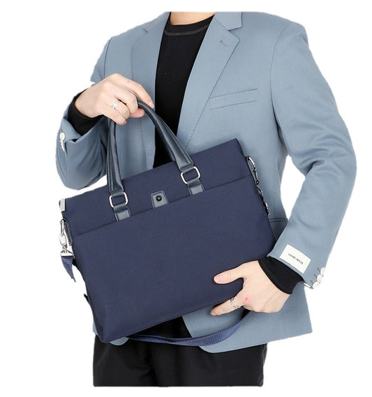 Navy business tote held by a man in a light blue suit