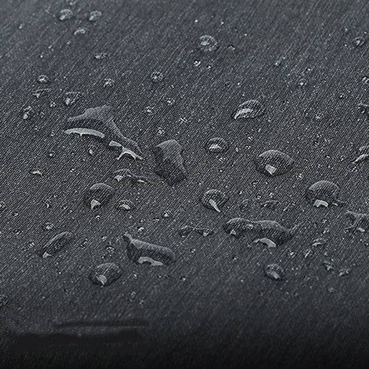 Close-up of the duffel's textured fabric with water droplets beaded on the surface