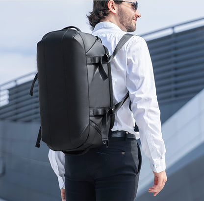 Black convertible duffel worn as a backpack, rear three-quarter view