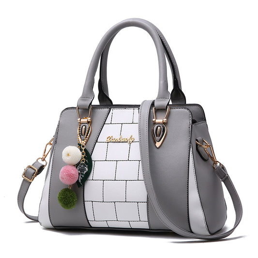Grey and white colour-block handbag with pom-pom charms and gold-tone hardware